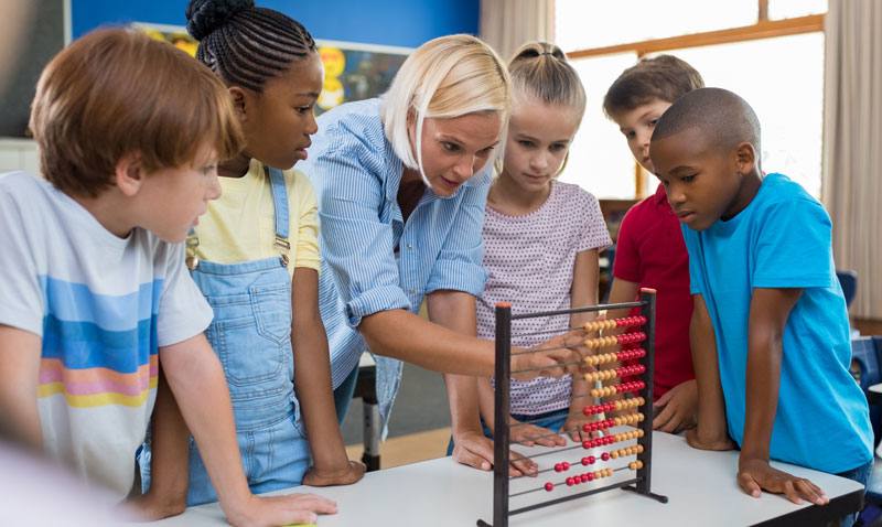 teacher-showing-abacus-to-children