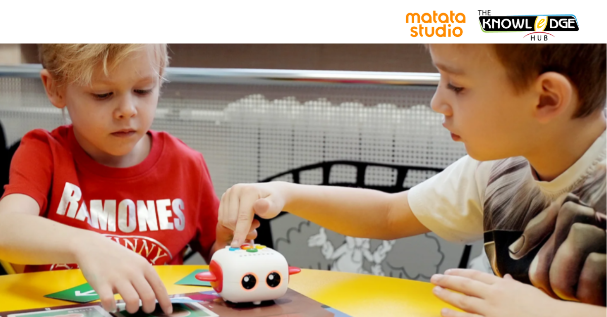 Two young children learning coding concepts using the Matata Studio educational robot, supported by The Knowledge Hub.